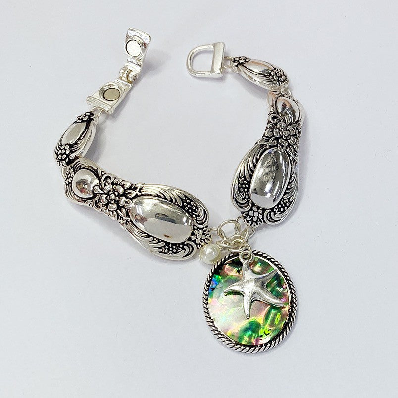 B0164 BB00437 Mother of Pearl Accented Starfish Shape Charms Bracelet
