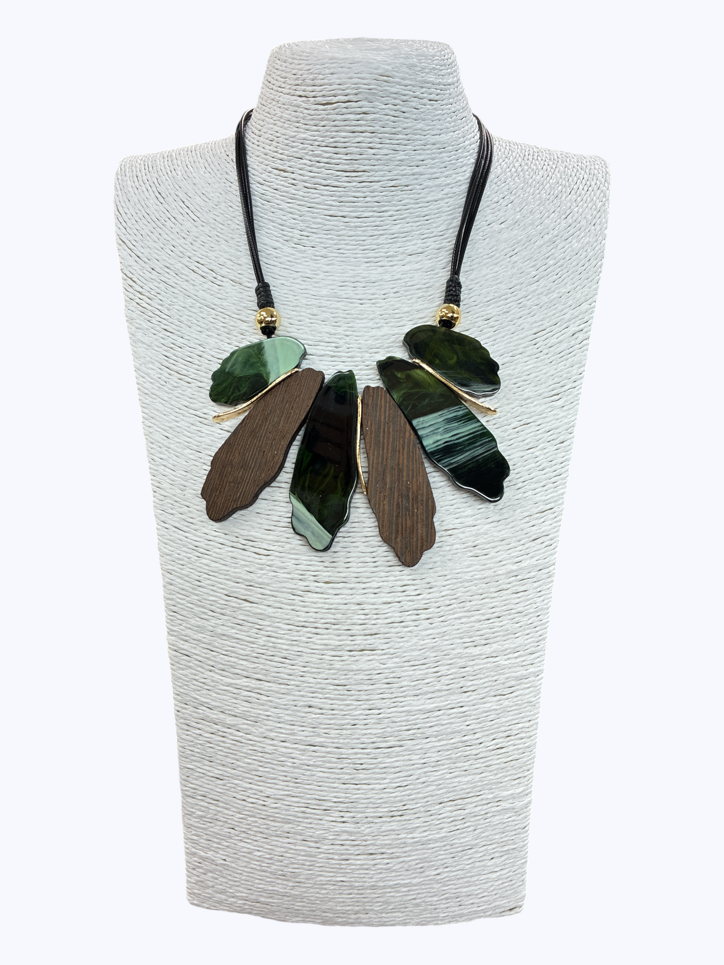 Abstract leaf statement necklace with green marbled and wood-textured pendants on black cord for a bold artisan boutique look.