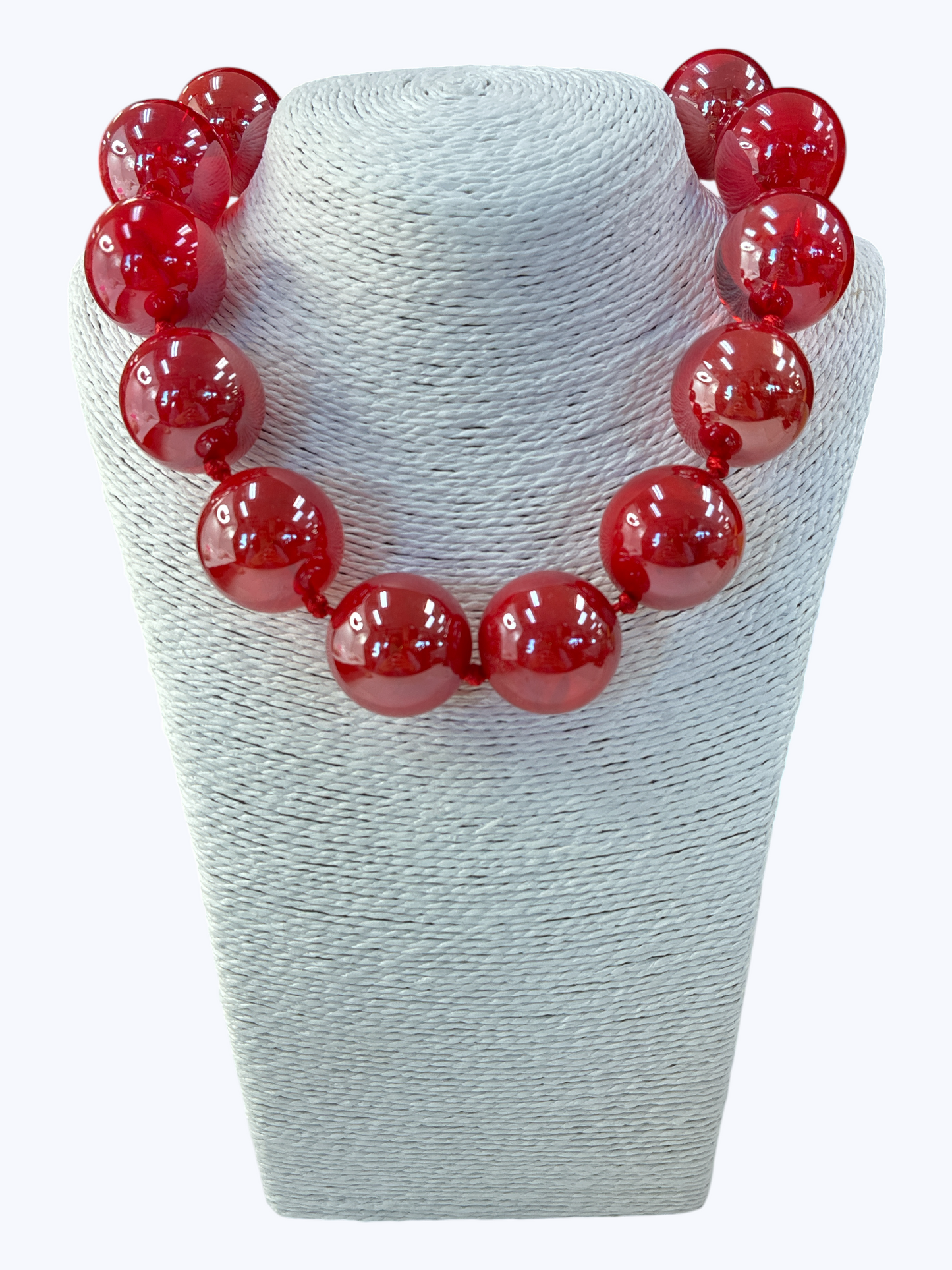 Red beaded necklace on a white mannequin bust