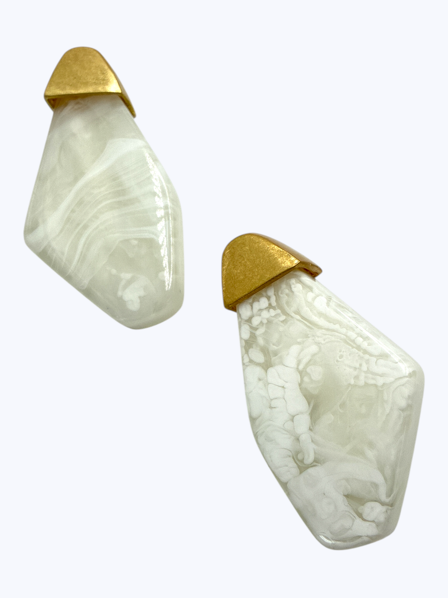 Modern geometric drop earrings featuring abstract marbled resin panels with metallic accent tops.