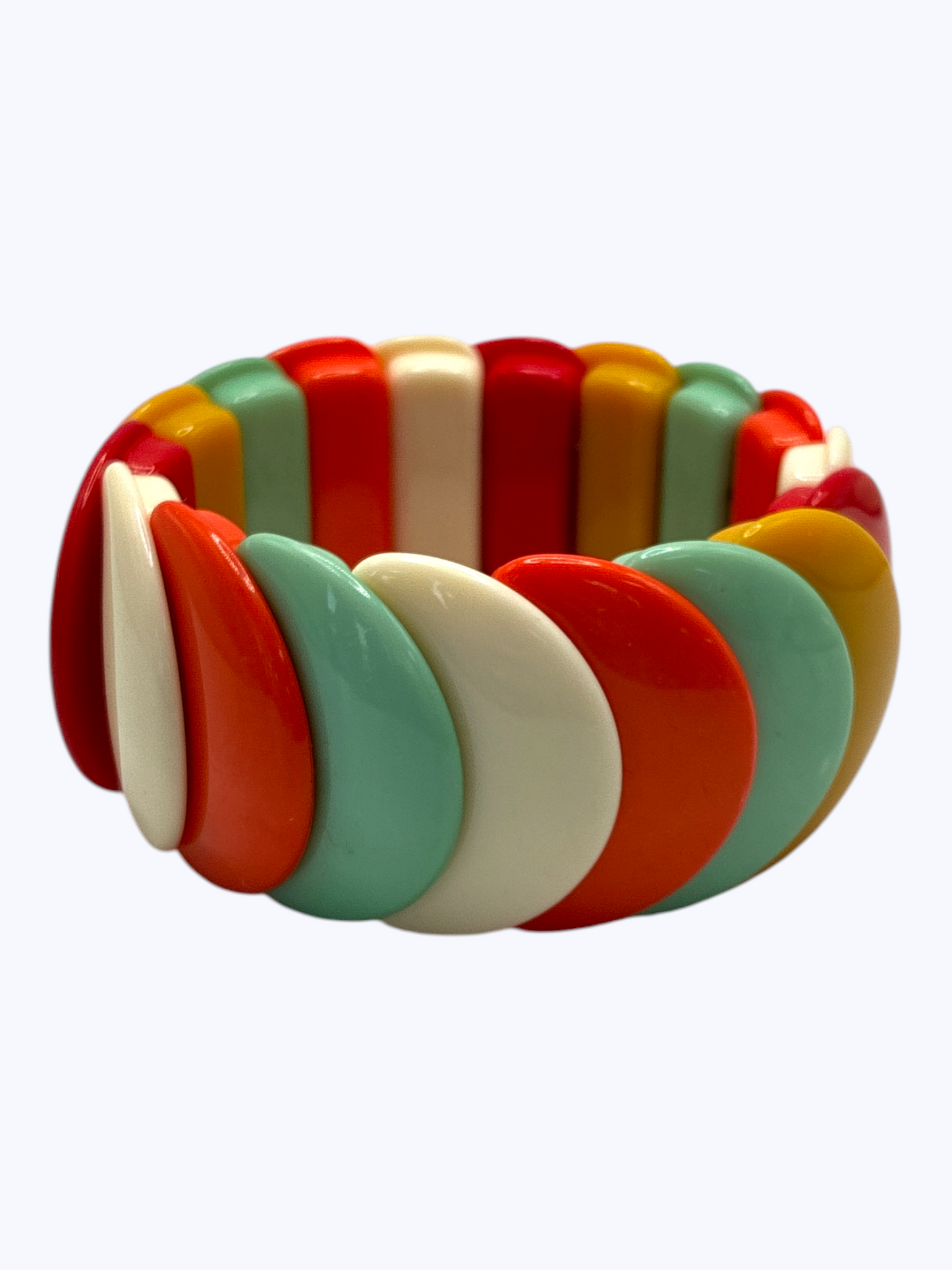 Colorful bracelet with red, green, yellow, and white segments on a white background