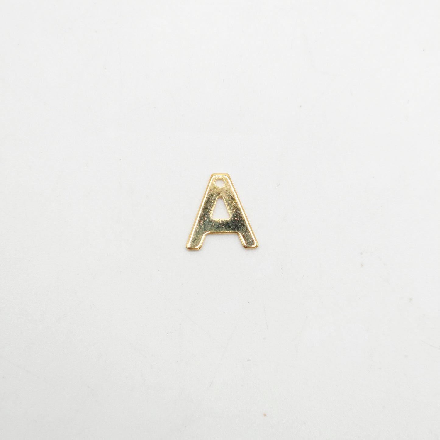 Gold letter 'A' charm on a white background
