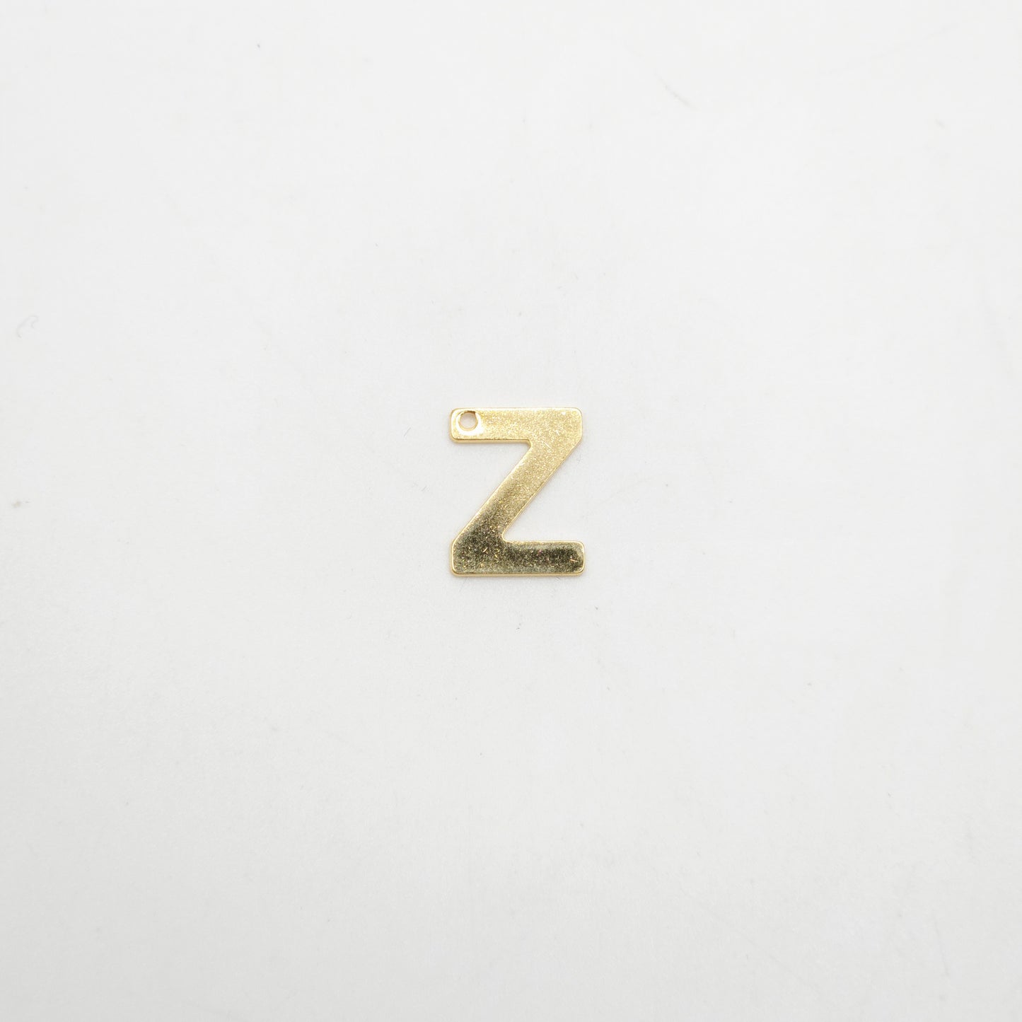 Gold letter 'Z' charm on a white background