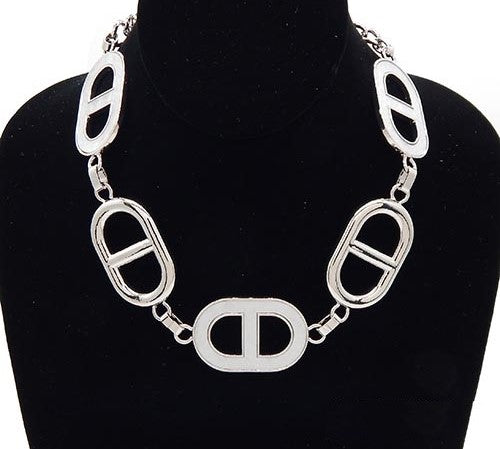 Silver necklace on a black mannequin bust
