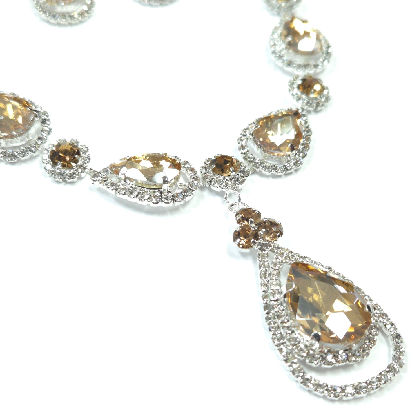 Close-up of a diamond necklace with brown gemstones on a white background
