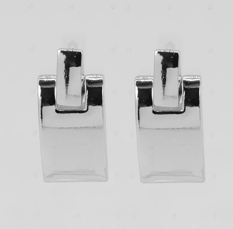 Pair of silver earrings on a light gray background