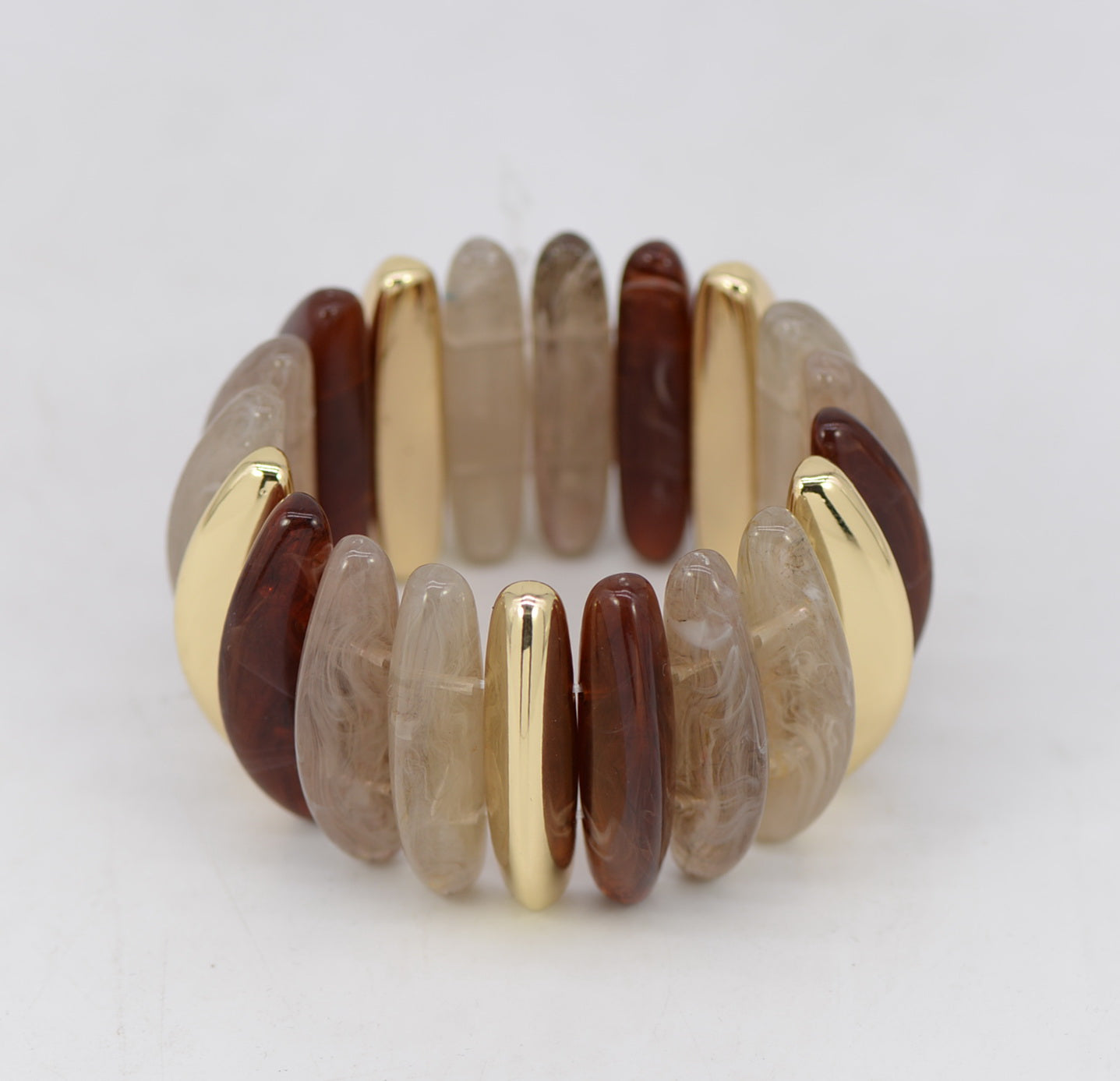 Bracelet with brown and gold beads on a white background