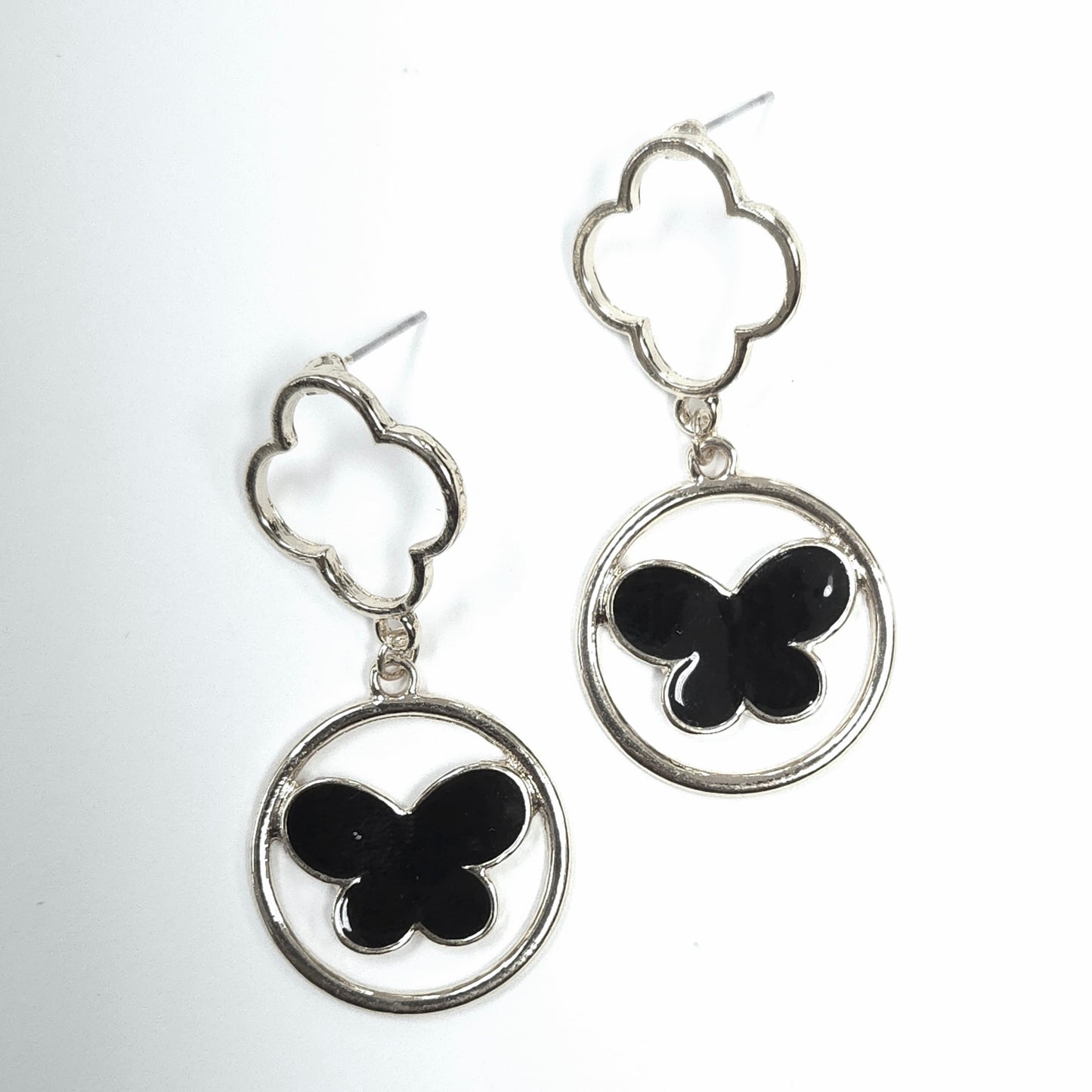 Butterfly-shaped earrings with silver and black design on a white background