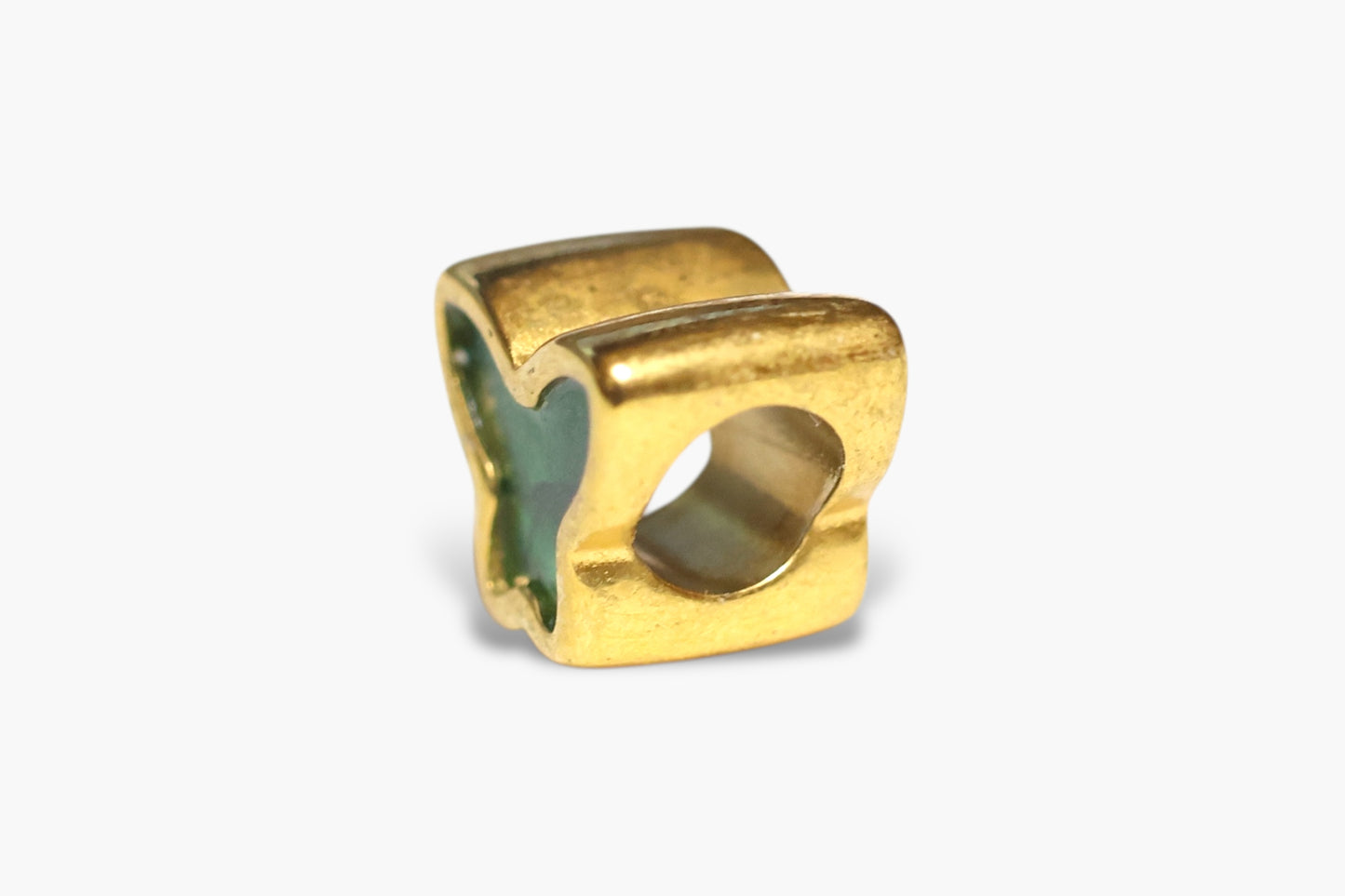 Gold ring with a green stone on a white background