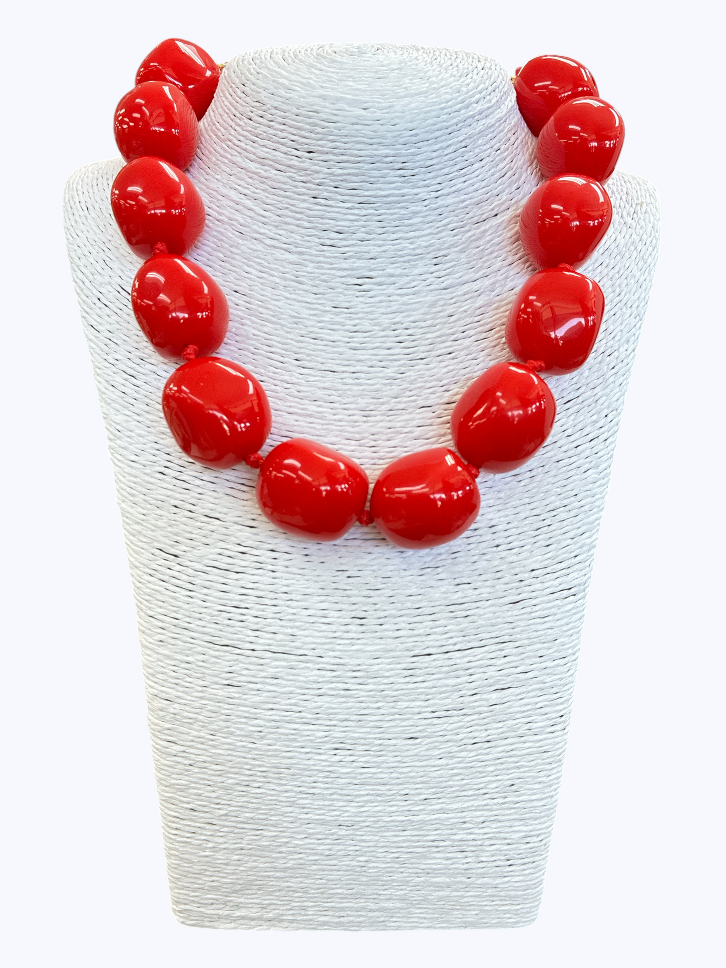 Chunky red statement necklace with oversized glossy resin beads for a bold contemporary boutique look.