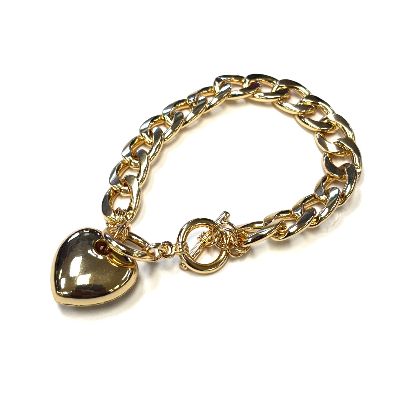 Gold chain bracelet with a heart-shaped charm on a white background