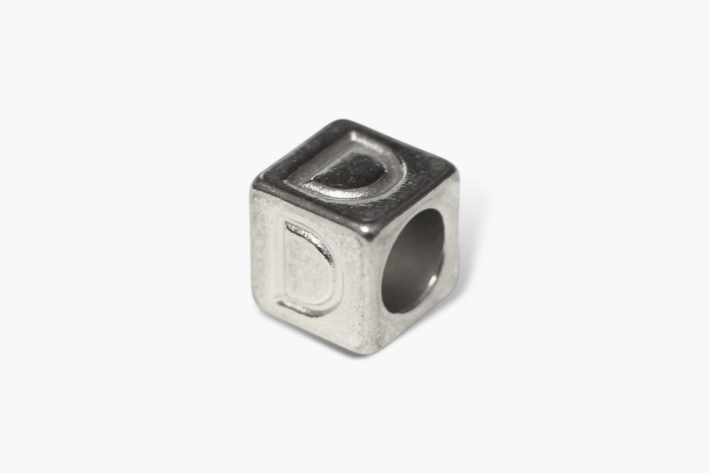 Silver cube-shaped charm with a letter 'D' on a white background