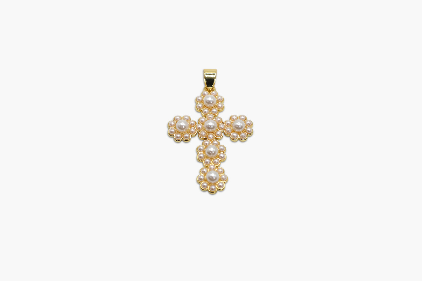 Gold cross pendant with pearls on a white background