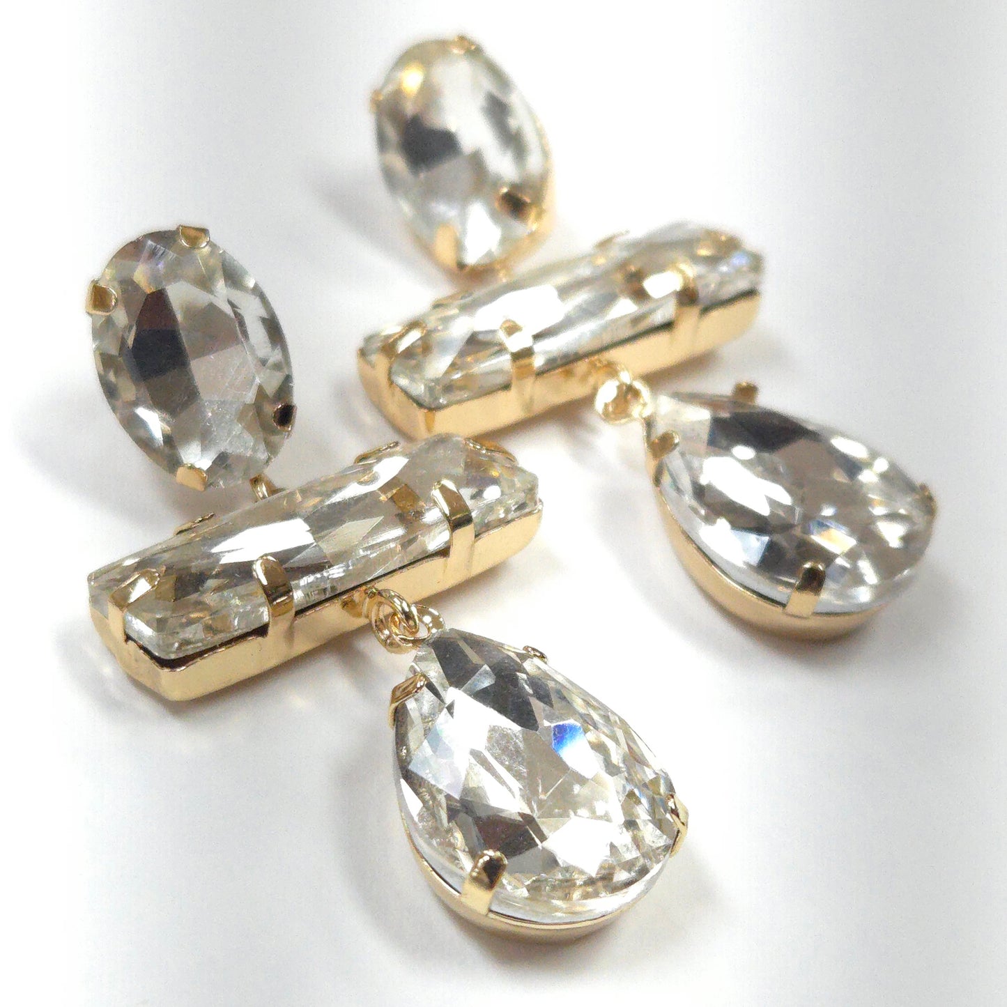 Pair of crystal earrings with gold accents on a white background