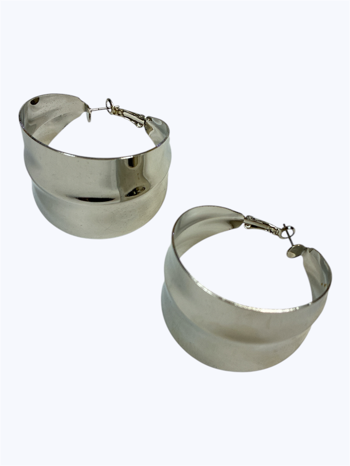 Wide polished hoop earrings with a bold curved silhouette and smooth metallic finish, designed in a modern oversized style.