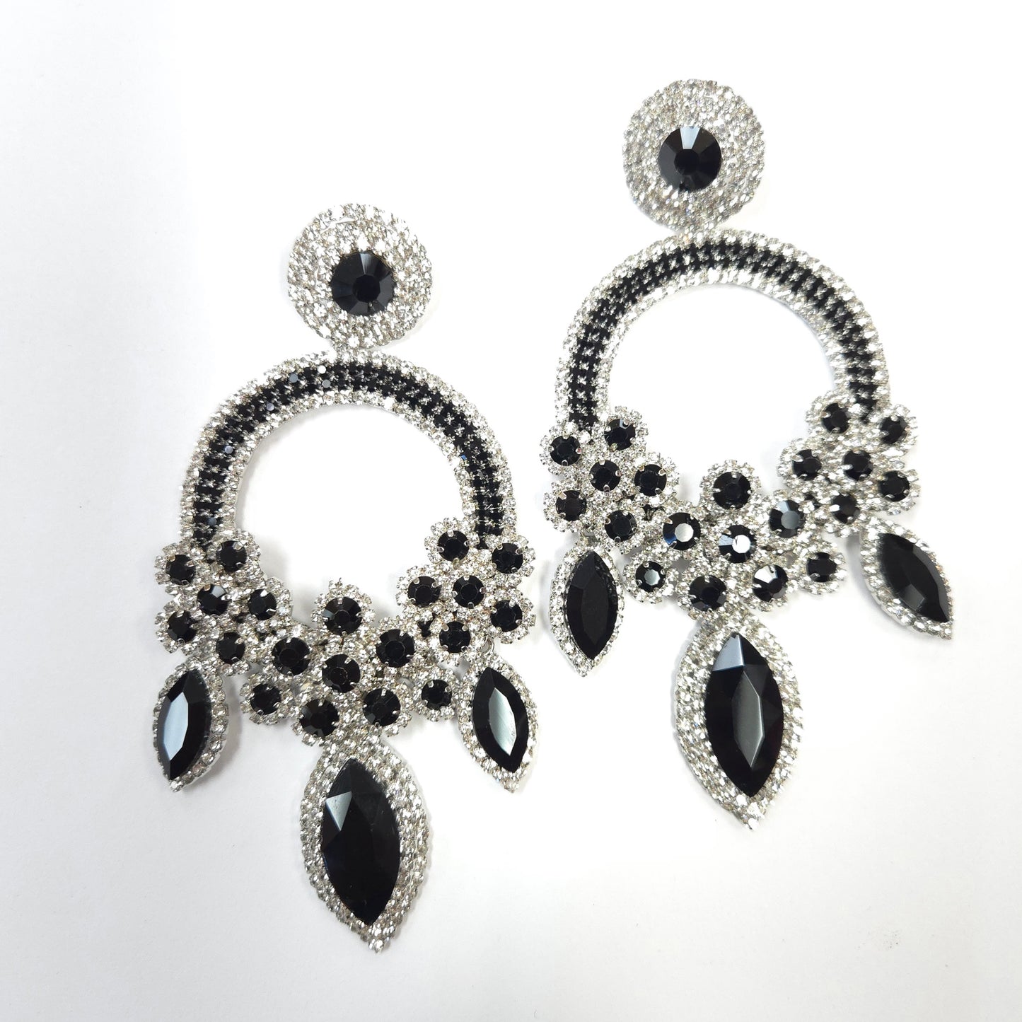Black and silver earrings on a white background