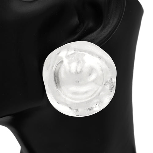 Close-up of a silver earring on a black background