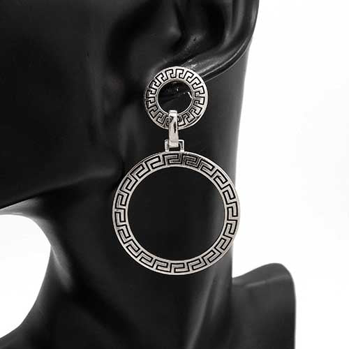 Double circle drop earrings with linked open ring design worn on mannequin ear with polished finish