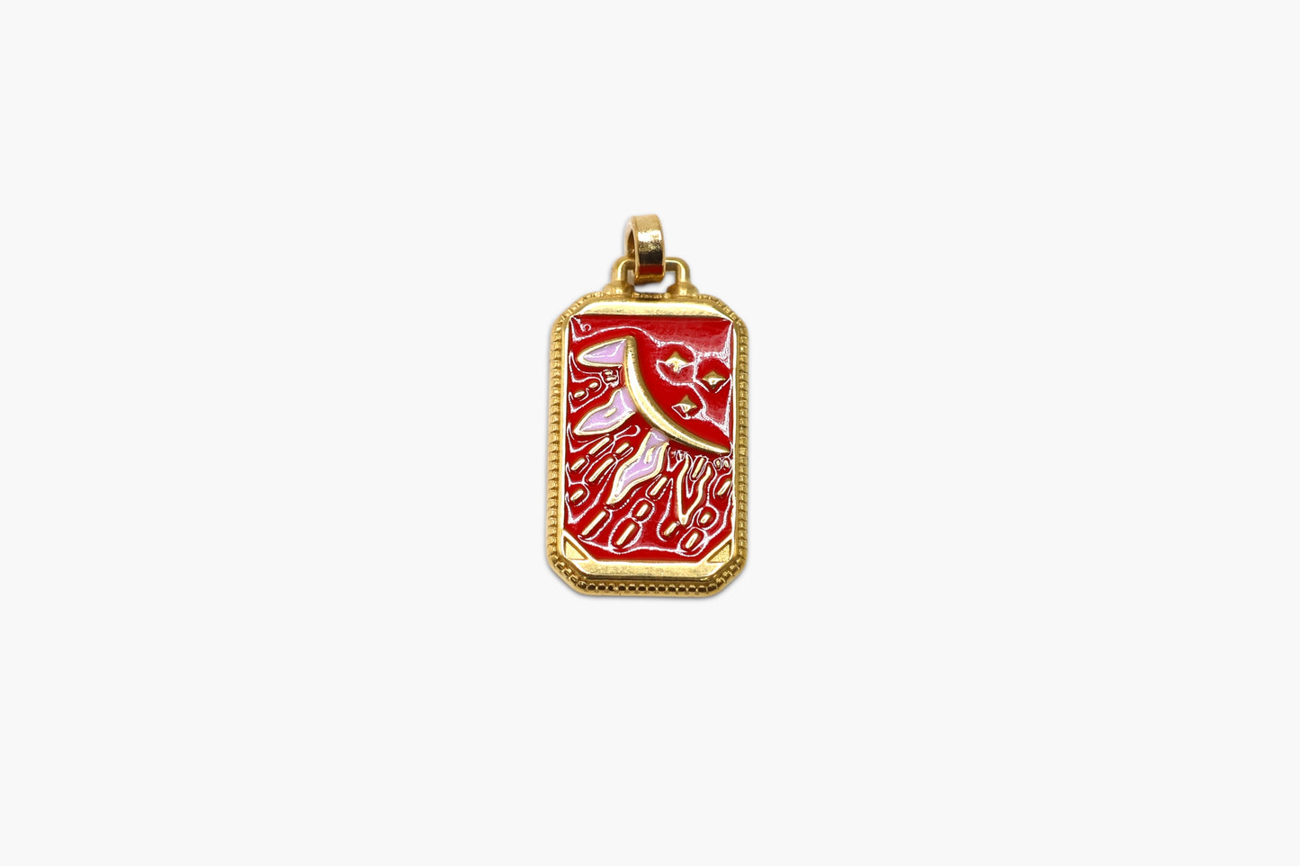 Gold pendant with red design on a white background