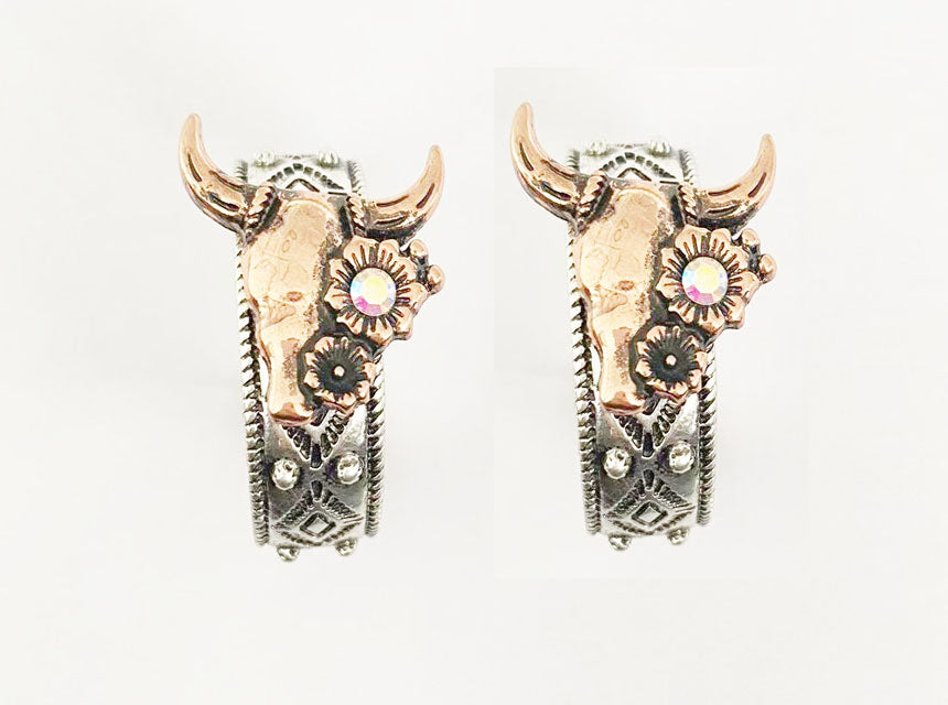 Pair of silver hoop earrings with intricate designs on a light gray background