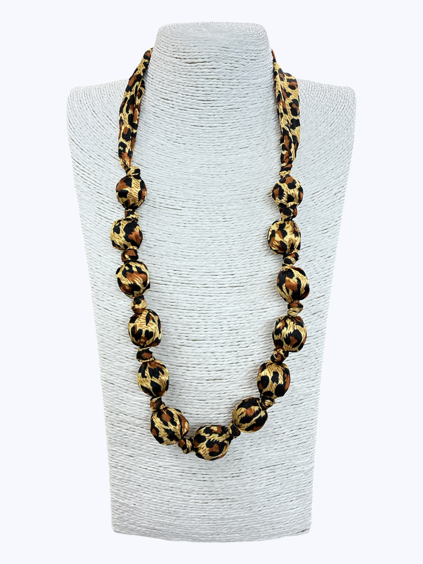 Leopard print necklace on a gray bust