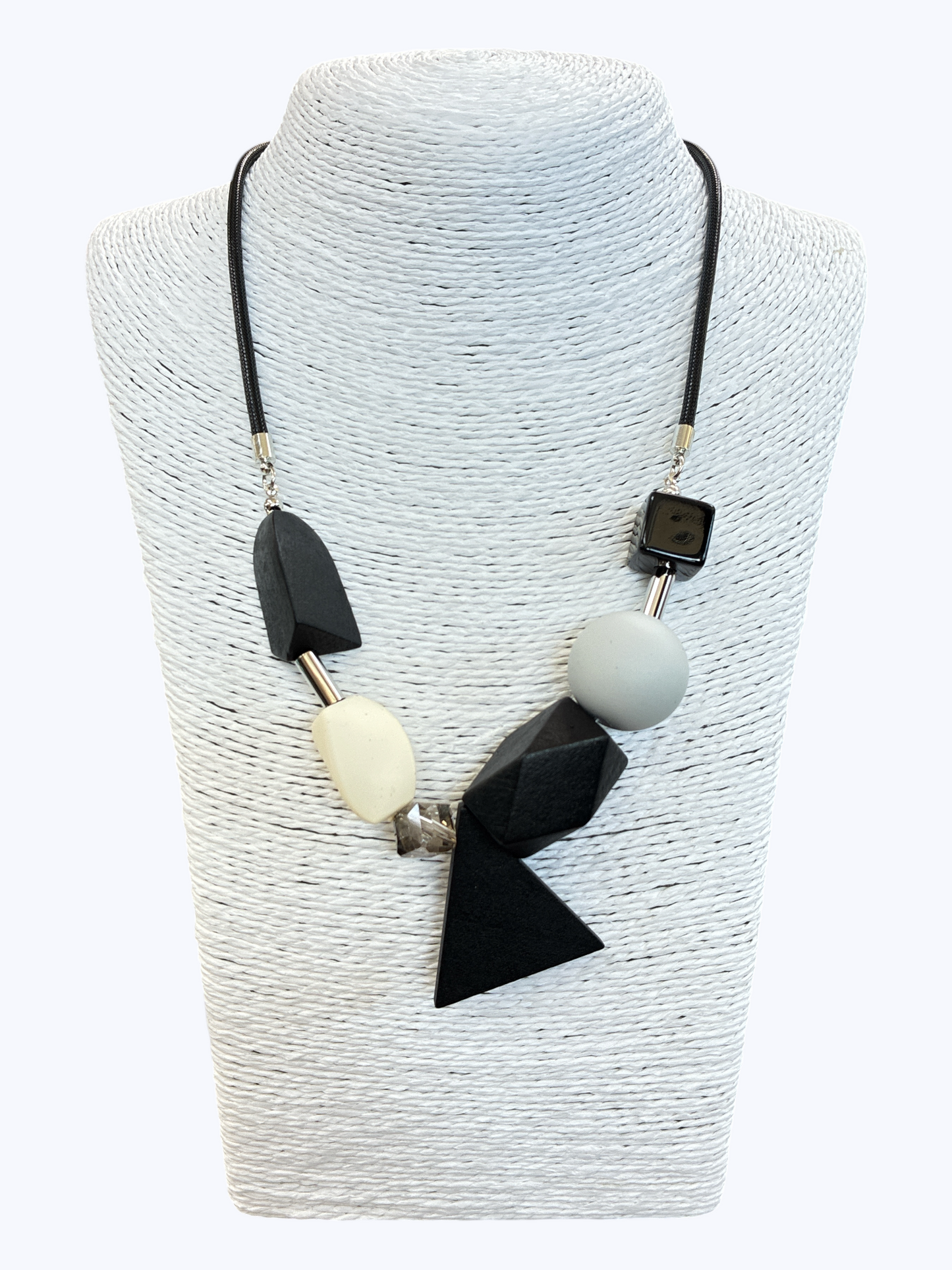 Black and gray geometric statement necklace with abstract resin and wood-inspired beads on black cord for a modern boutique look.