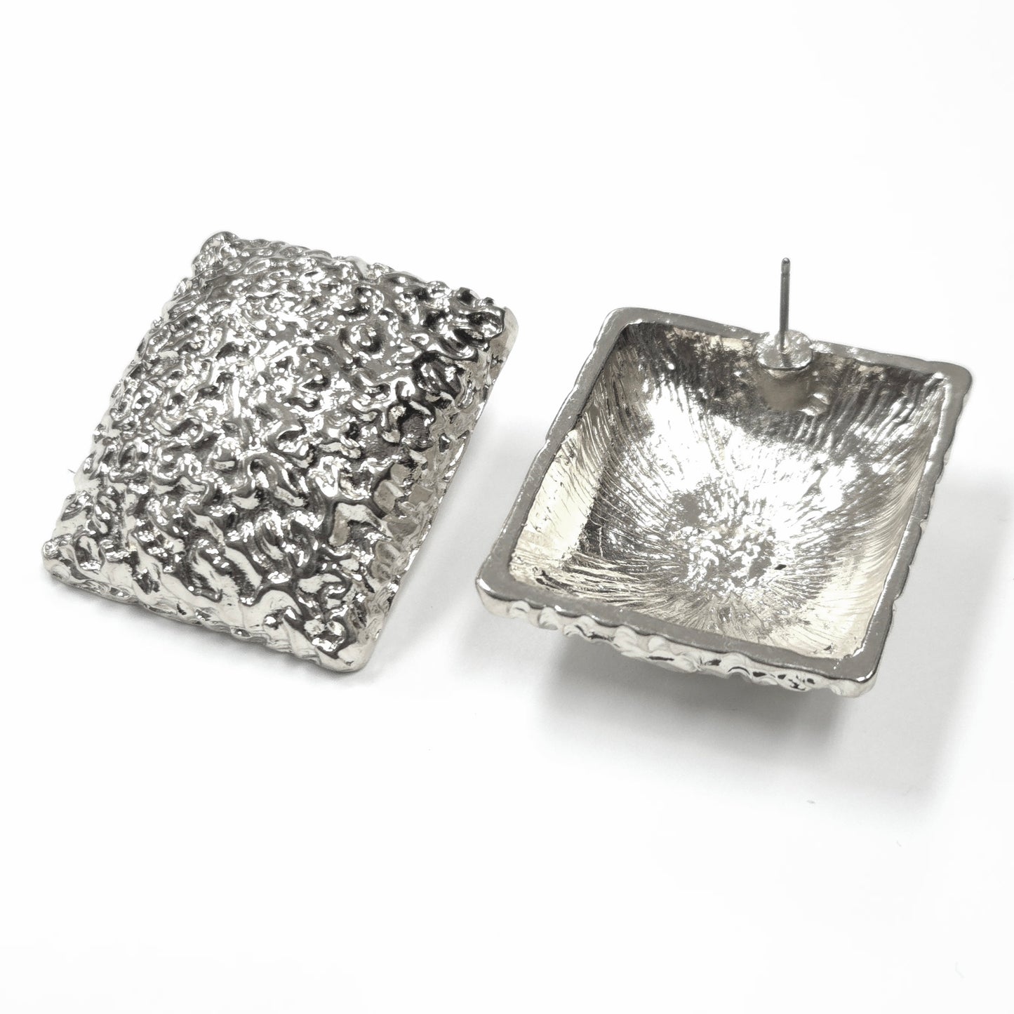 Two silver square candle holders on a white background