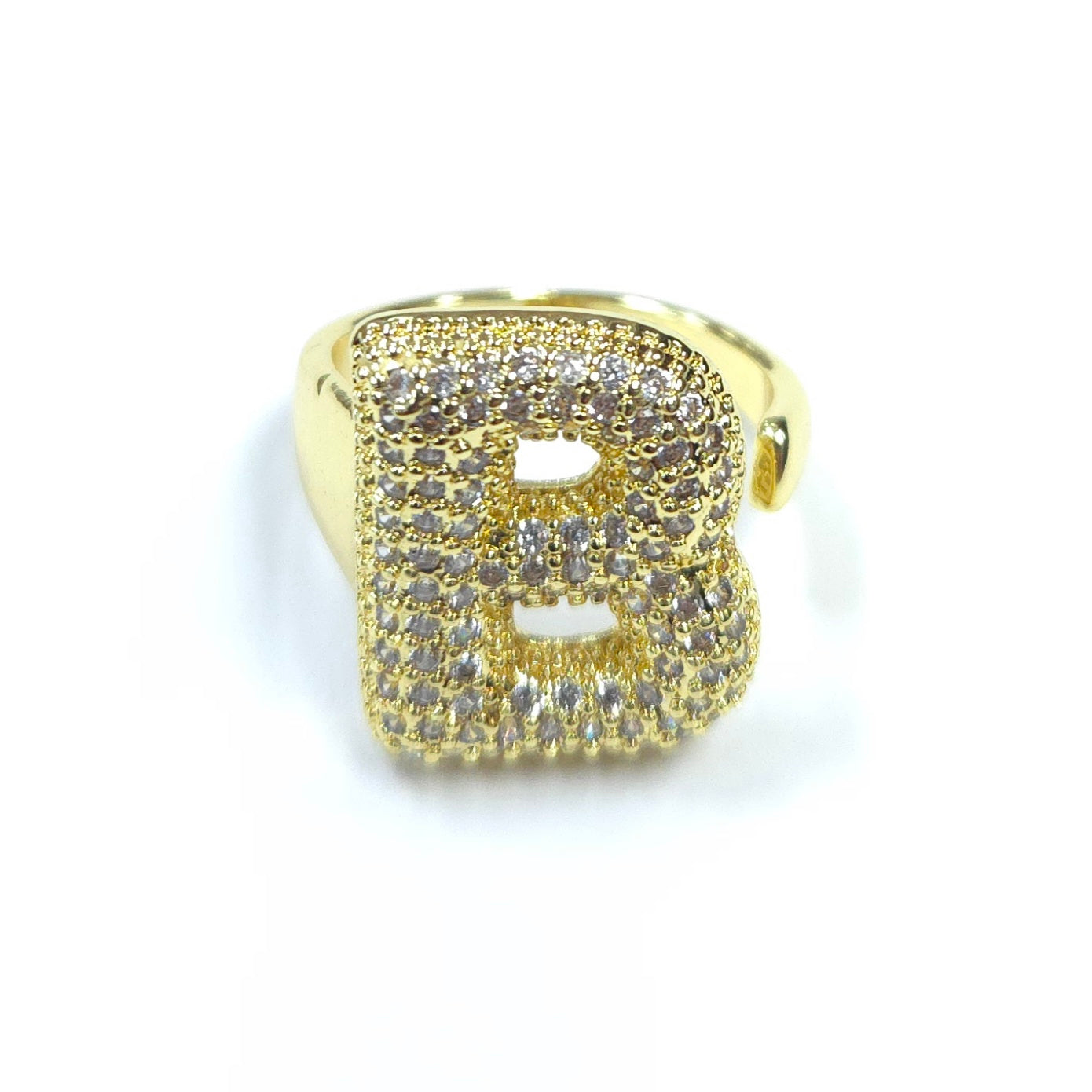 Gold ring with letter 'B' design on a white background