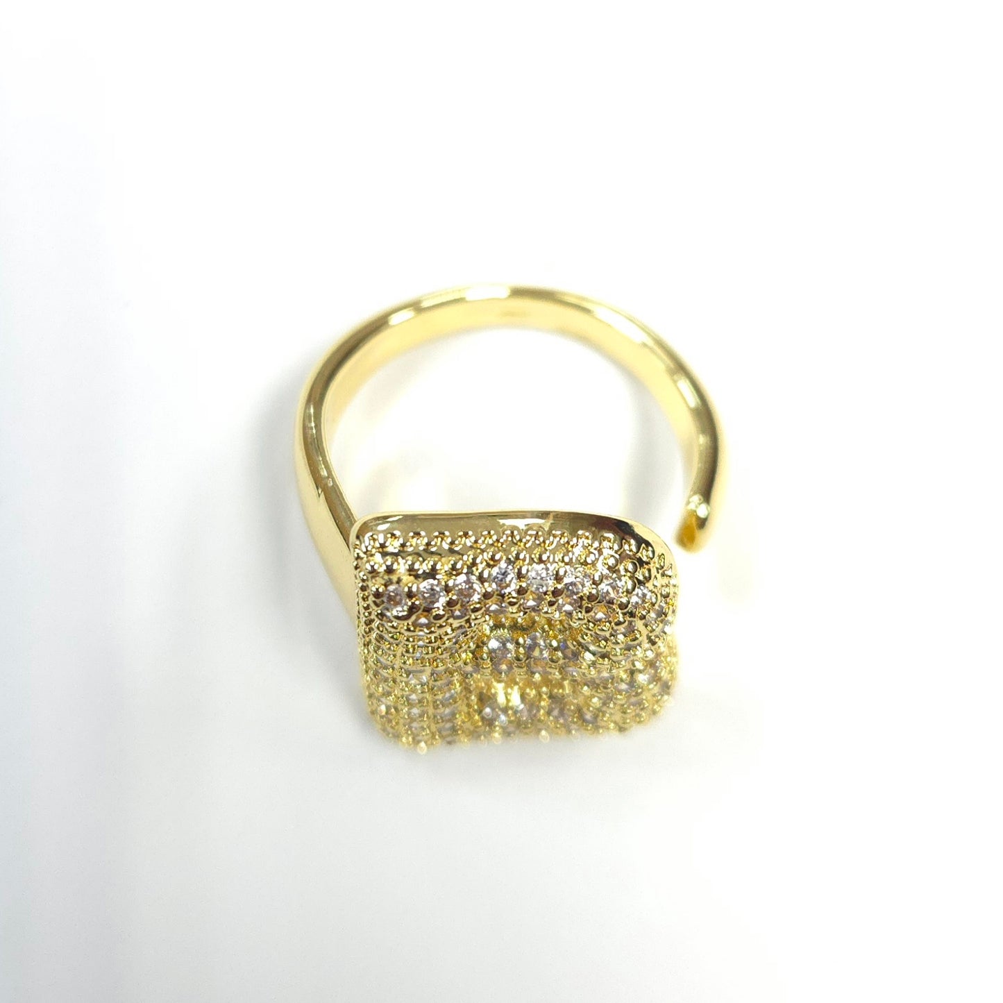 Gold ring with diamond accents on a white background