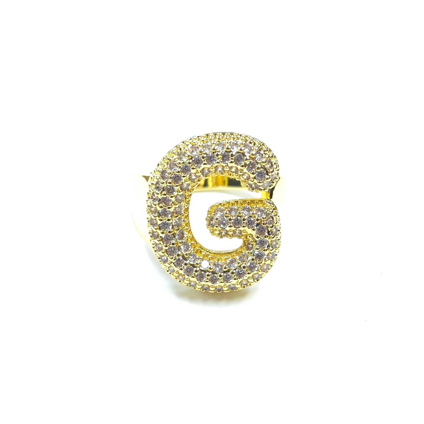 Gold letter 'G' brooch with gemstones on a white background
