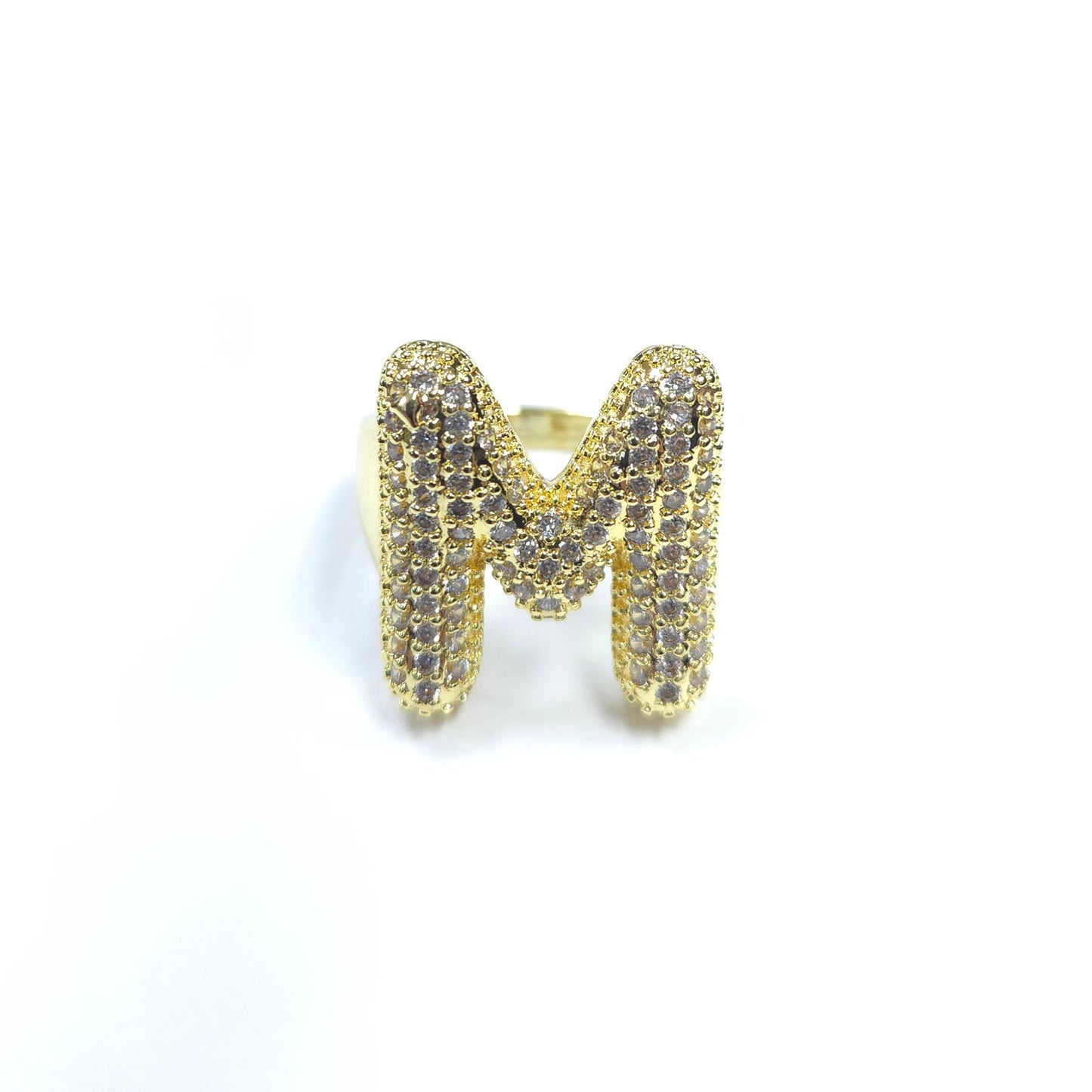 Gold ring with letter 'M' design on a white background