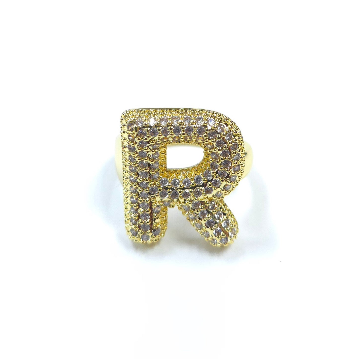 Gold letter 'R' charm with gemstones on a white background
