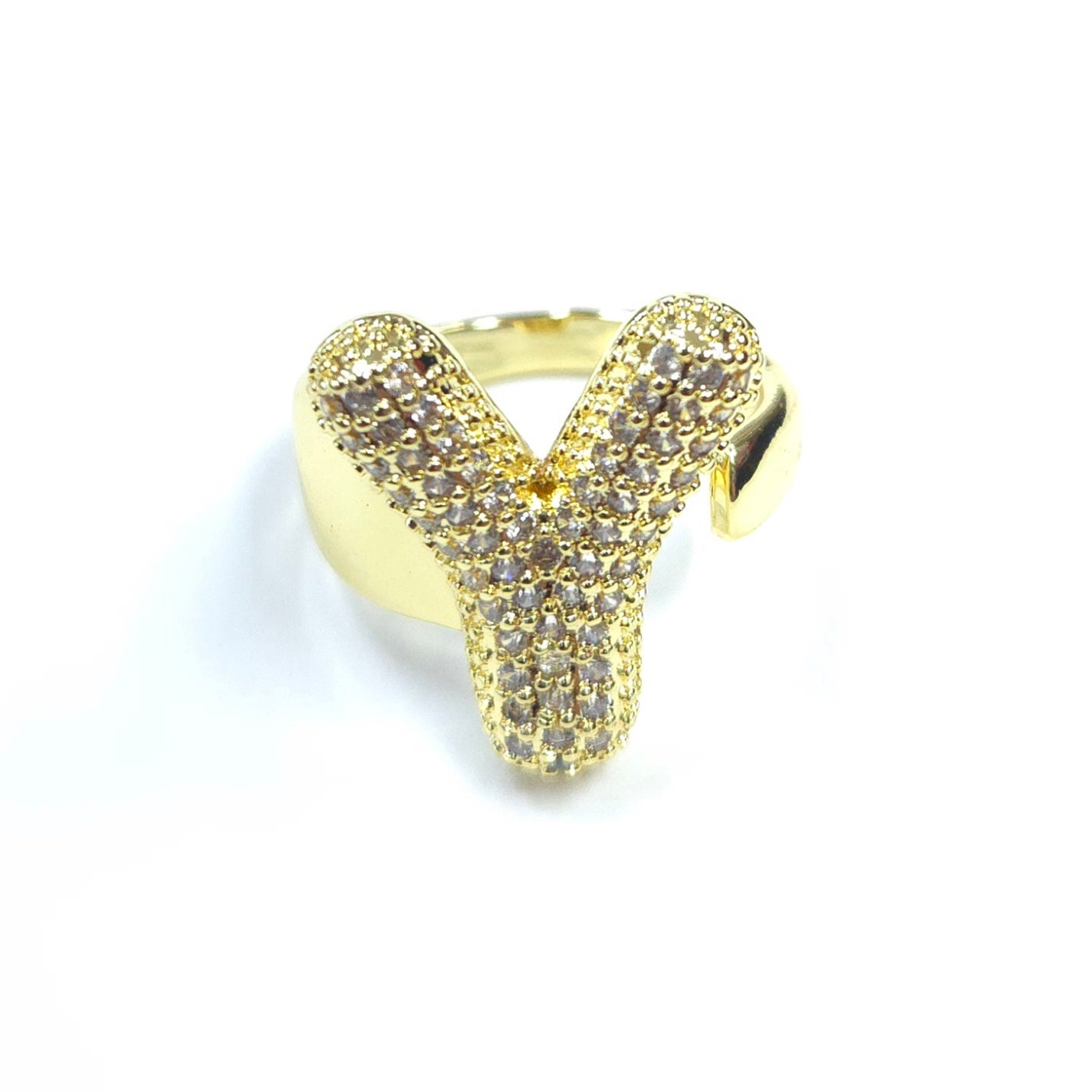 Gold ring with diamond-like stones on a white background