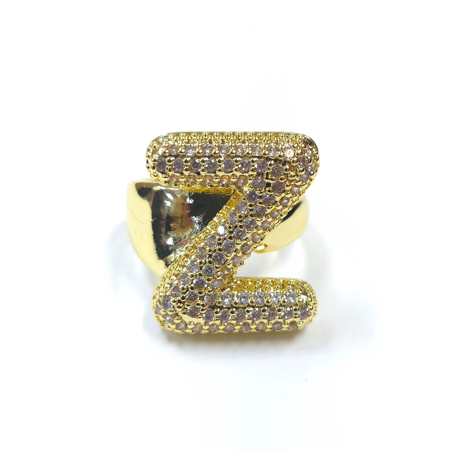 Gold ring with a z-shaped design on a white background
