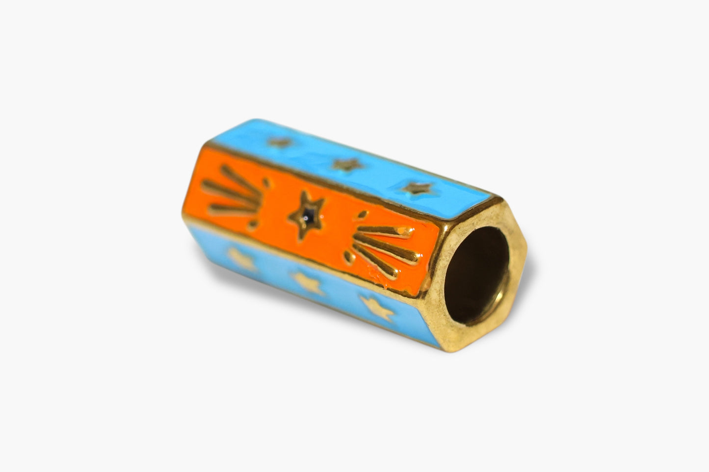 Decorative cylindrical object with orange and blue design on a white background
