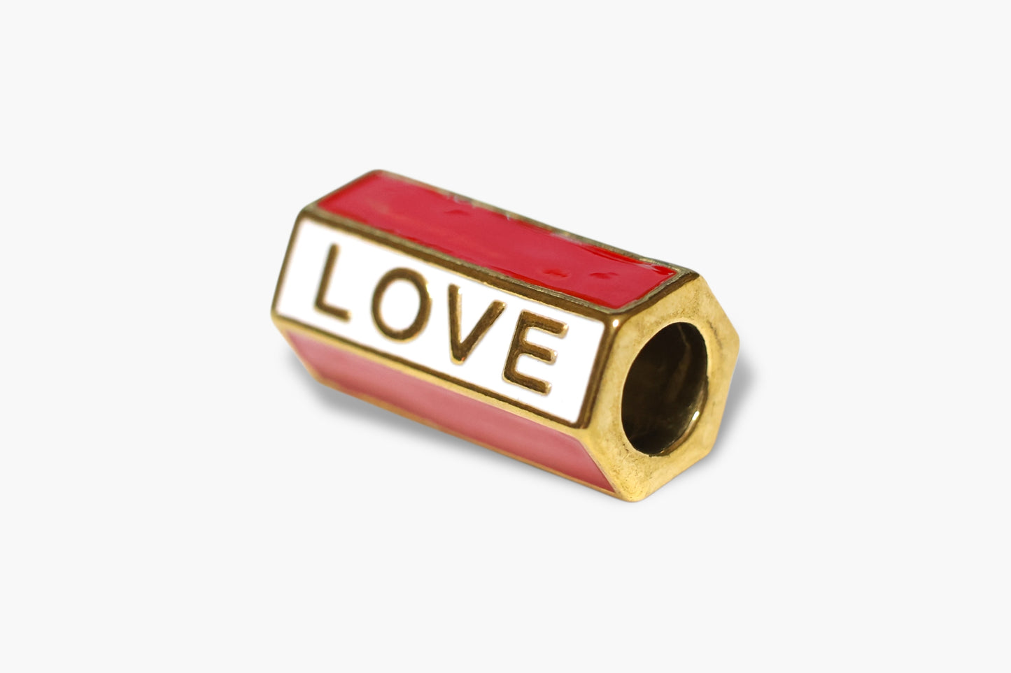Gold and red charm with 'LOVE' engraving on a white background