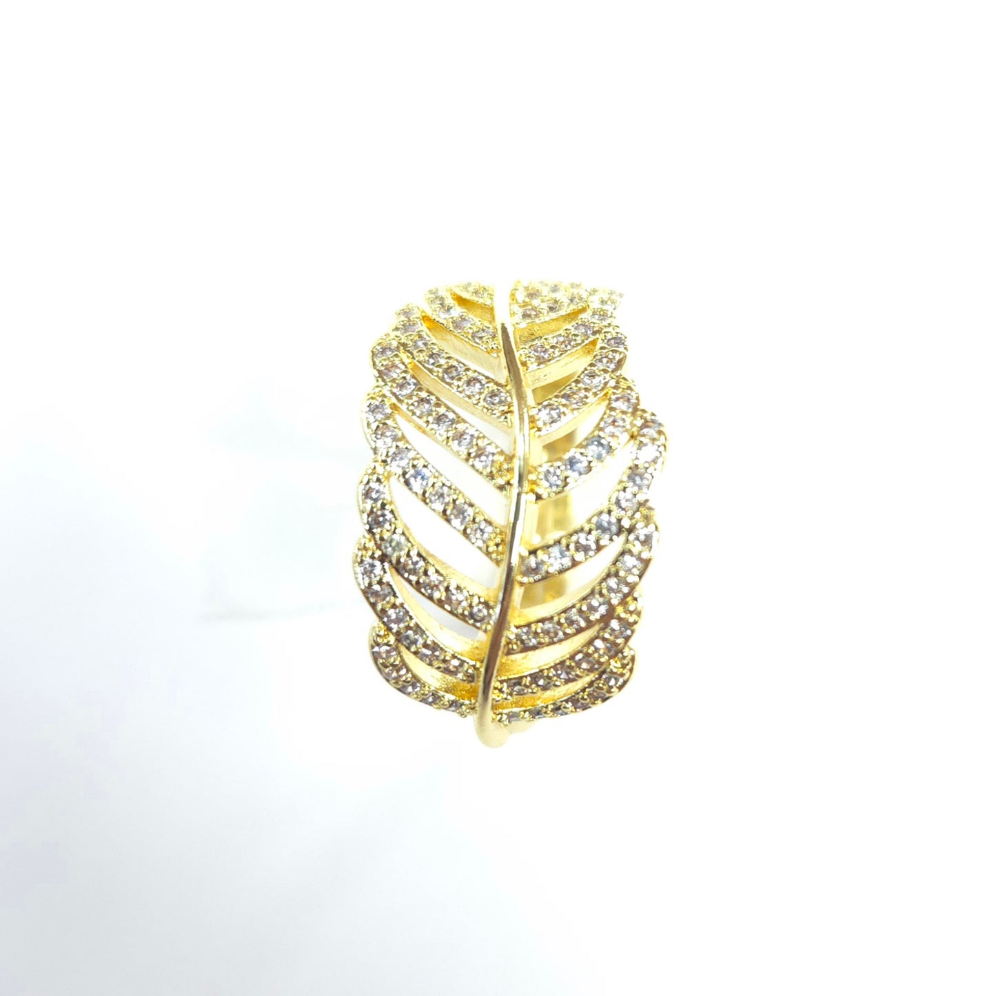 Gold leaf-shaped ring with embedded crystals on a white background