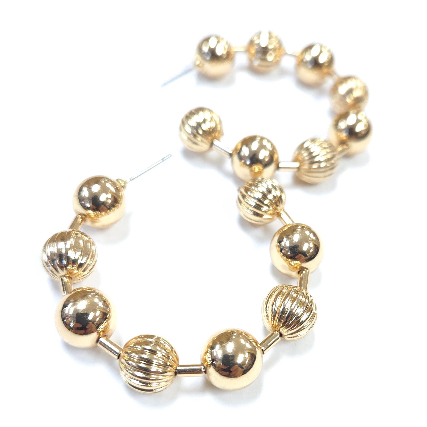 Gold beaded bracelet on a white background