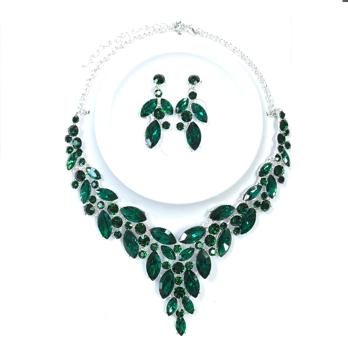 Jewelry set with green gemstones on a white background