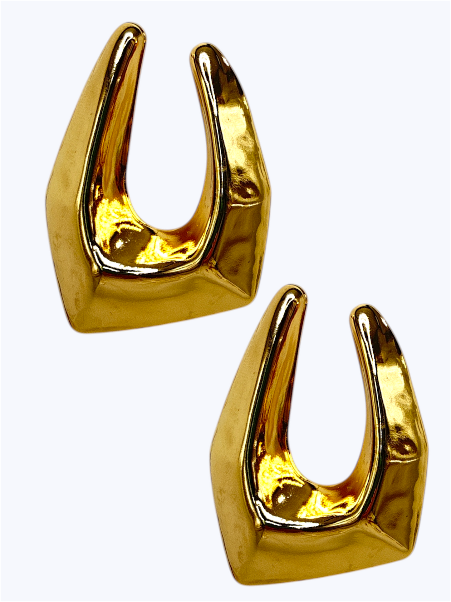 Abstract geometric hollow drop earrings with sculpted polished metal design displayed on jewelry card packaging.