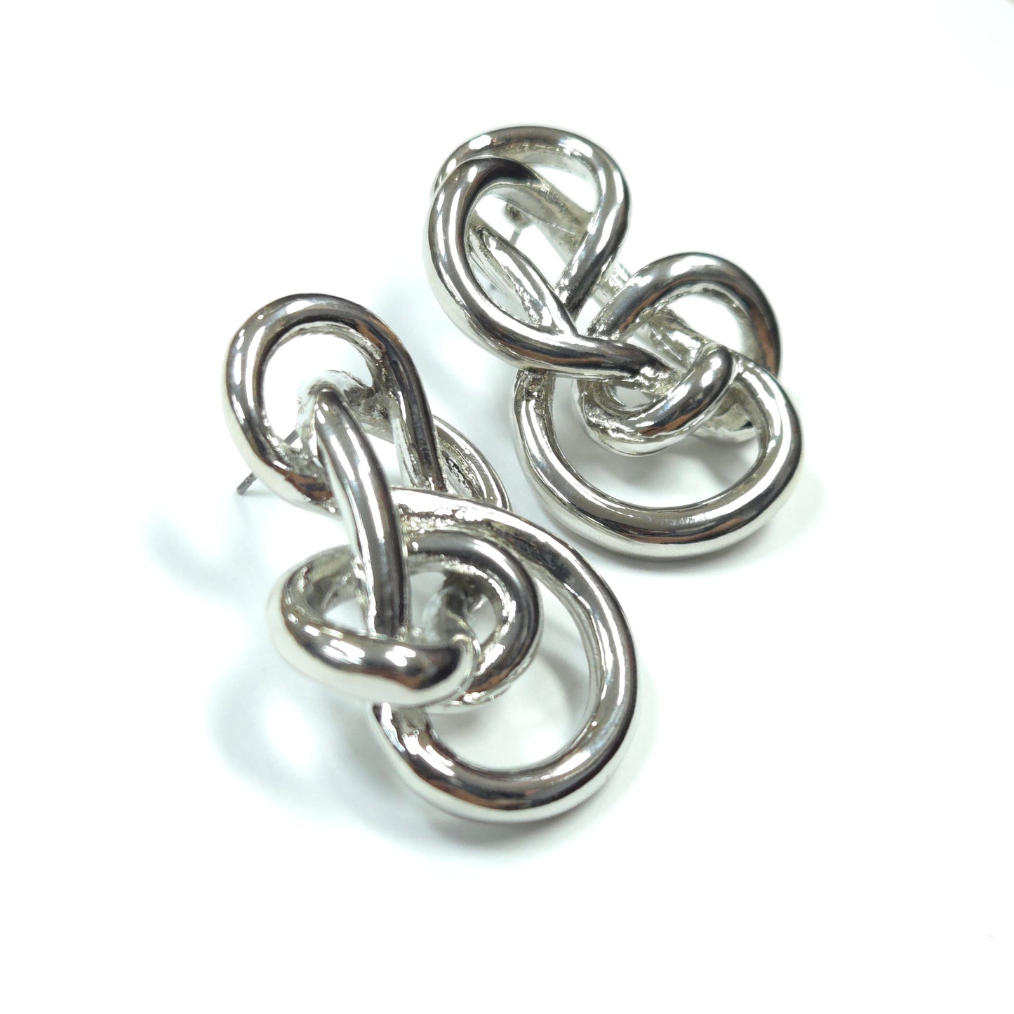 Pair of silver earrings with interlocking design on a white background
