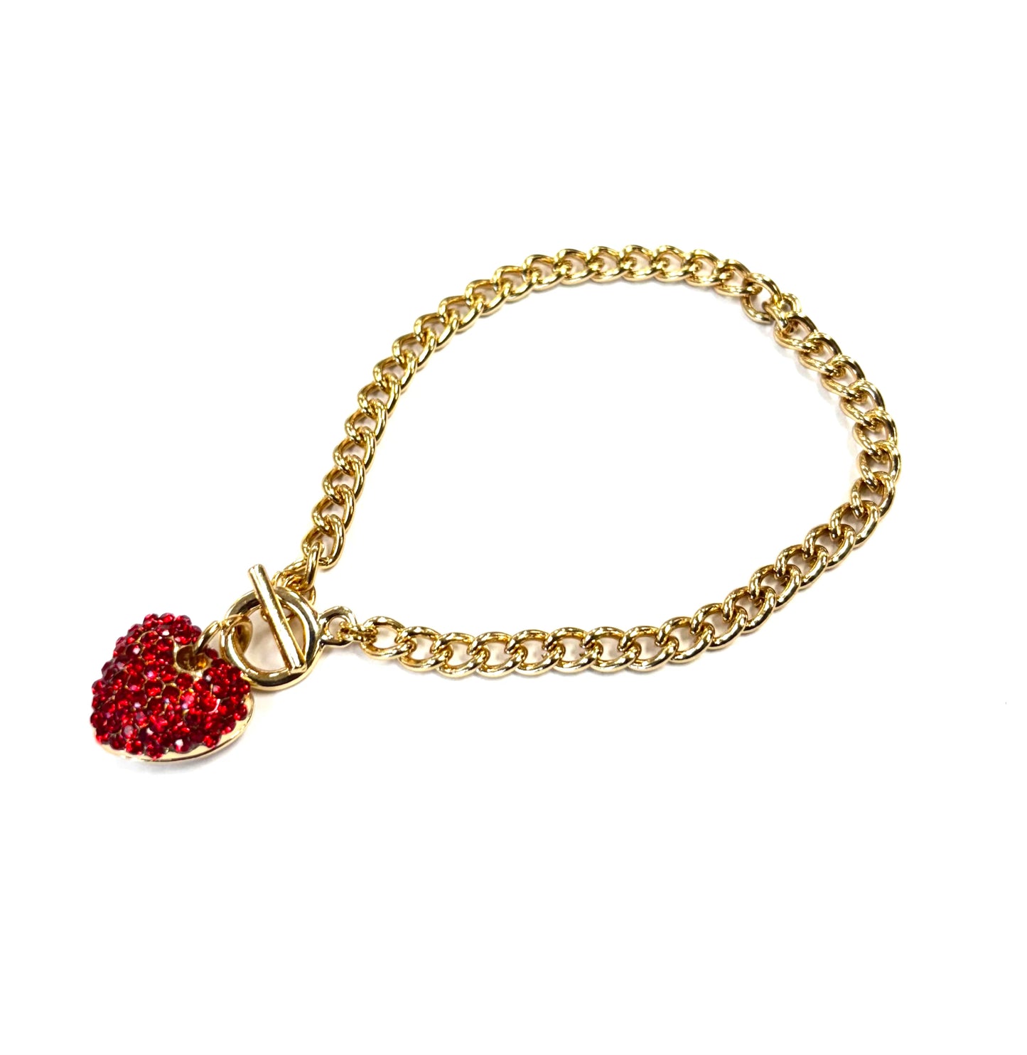 Gold chain bracelet with a red heart charm on a white background