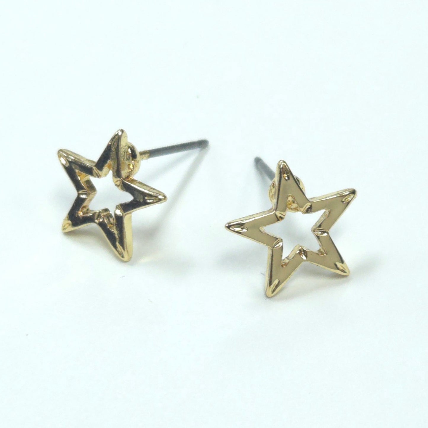 Gold star-shaped earrings on a white background