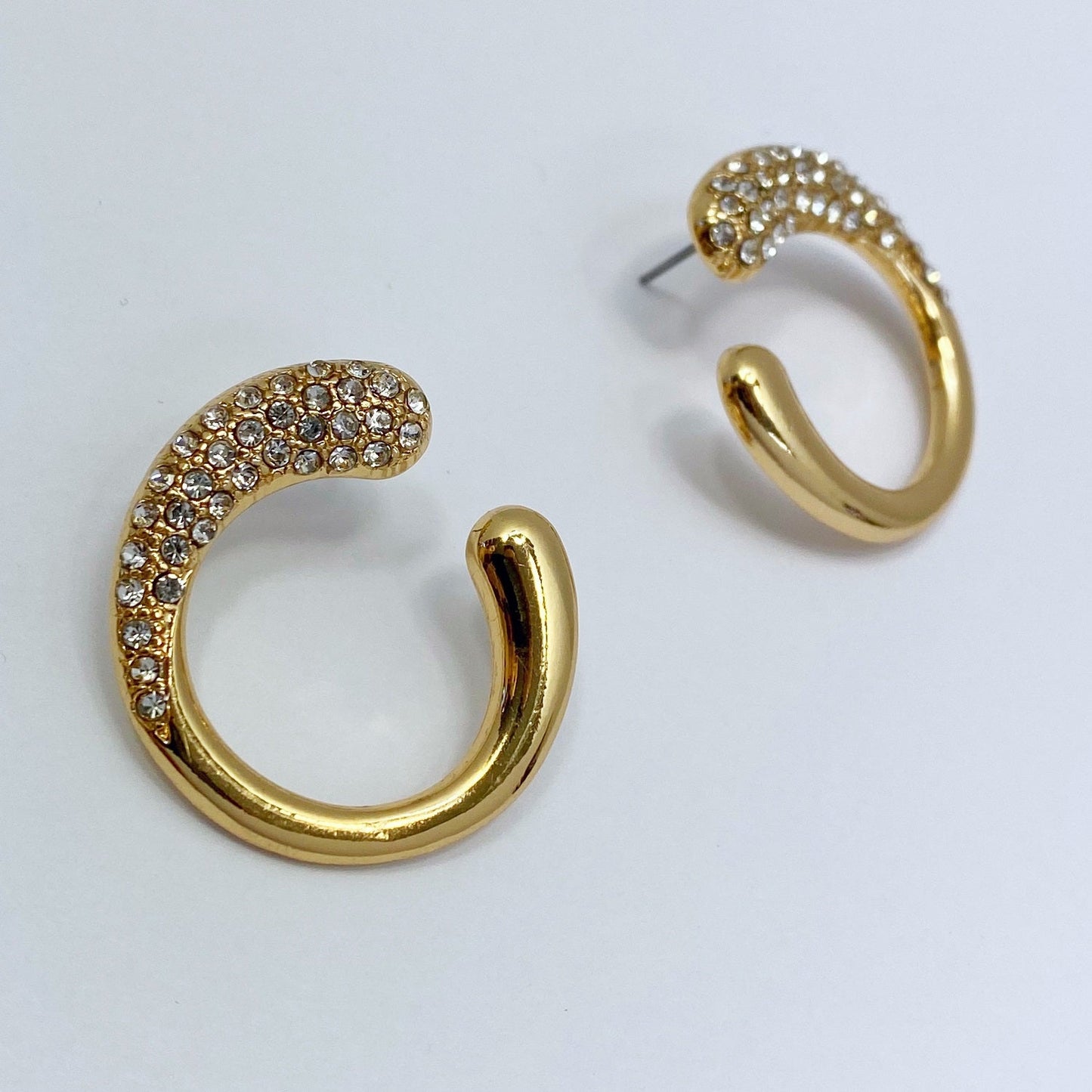 a Gold earrings on a white background