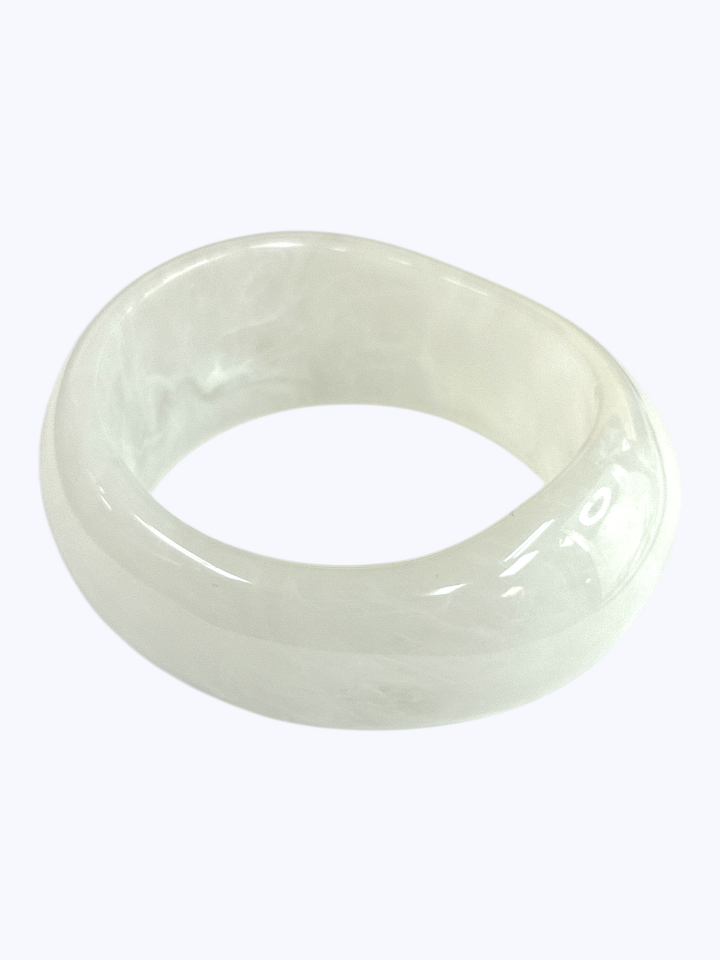 Glossy marbled resin bangle bracelet with chunky rounded silhouette and polished finish.