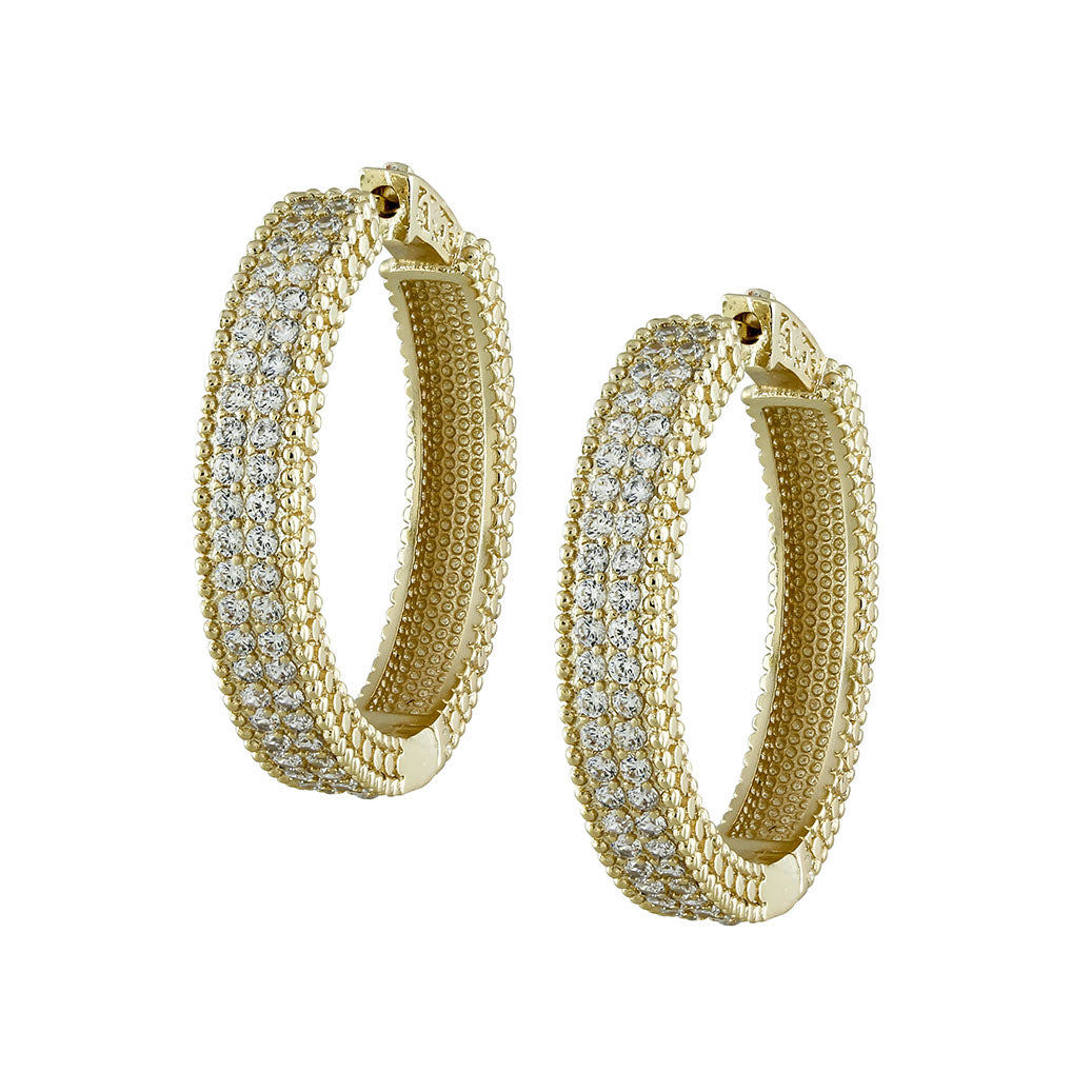 Gold hoop earrings with embedded diamonds on a white background