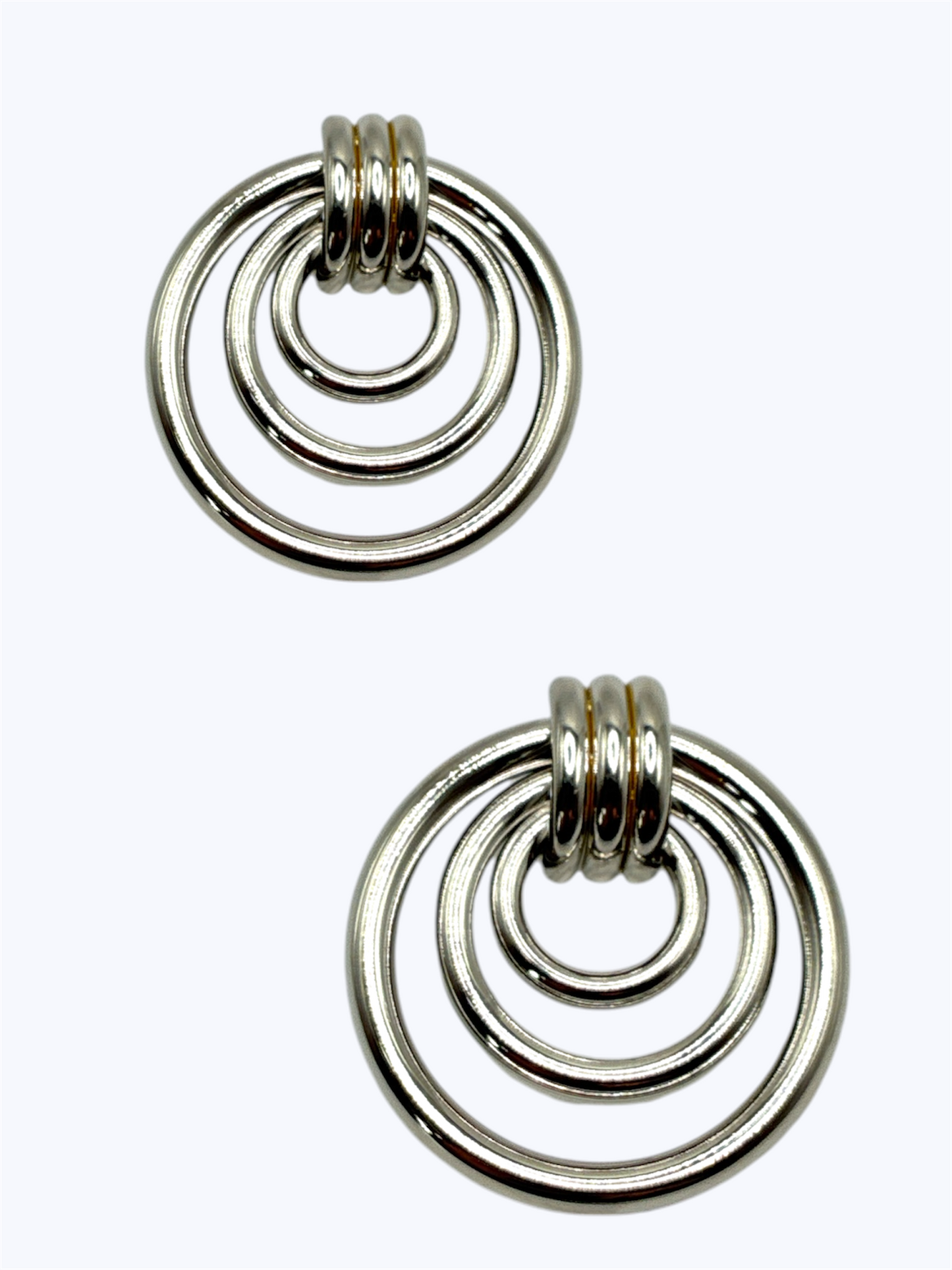 Pair of silver hoop earrings on a white background