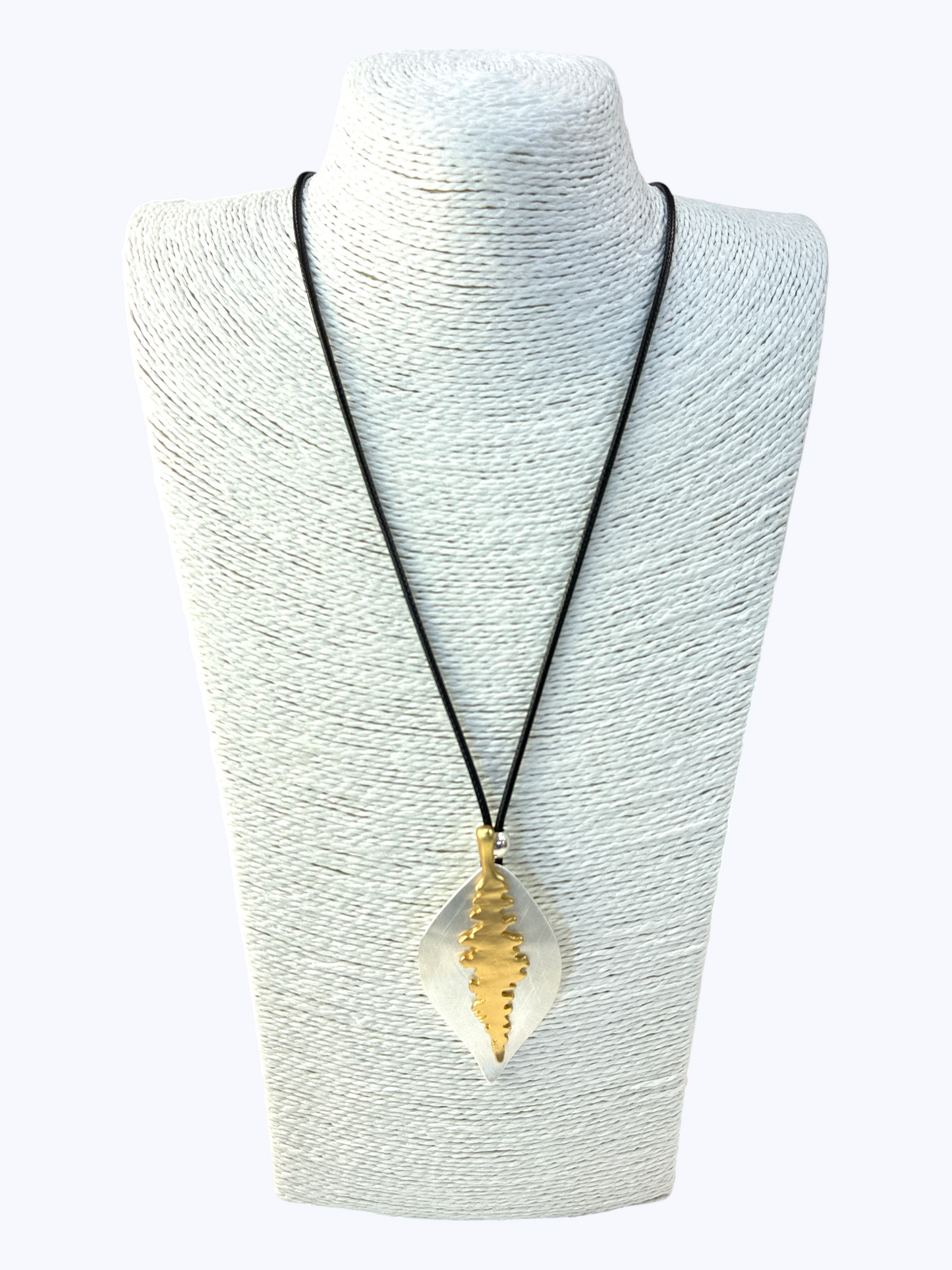 Necklace with a gold pendant on a mannequin bust against a white background