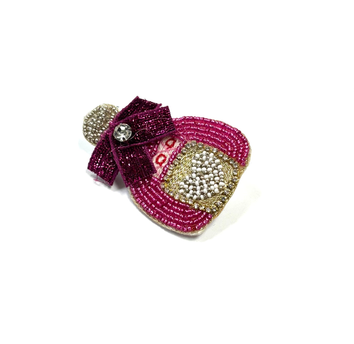 Decorative brooch with pink and gold elements on a white background
