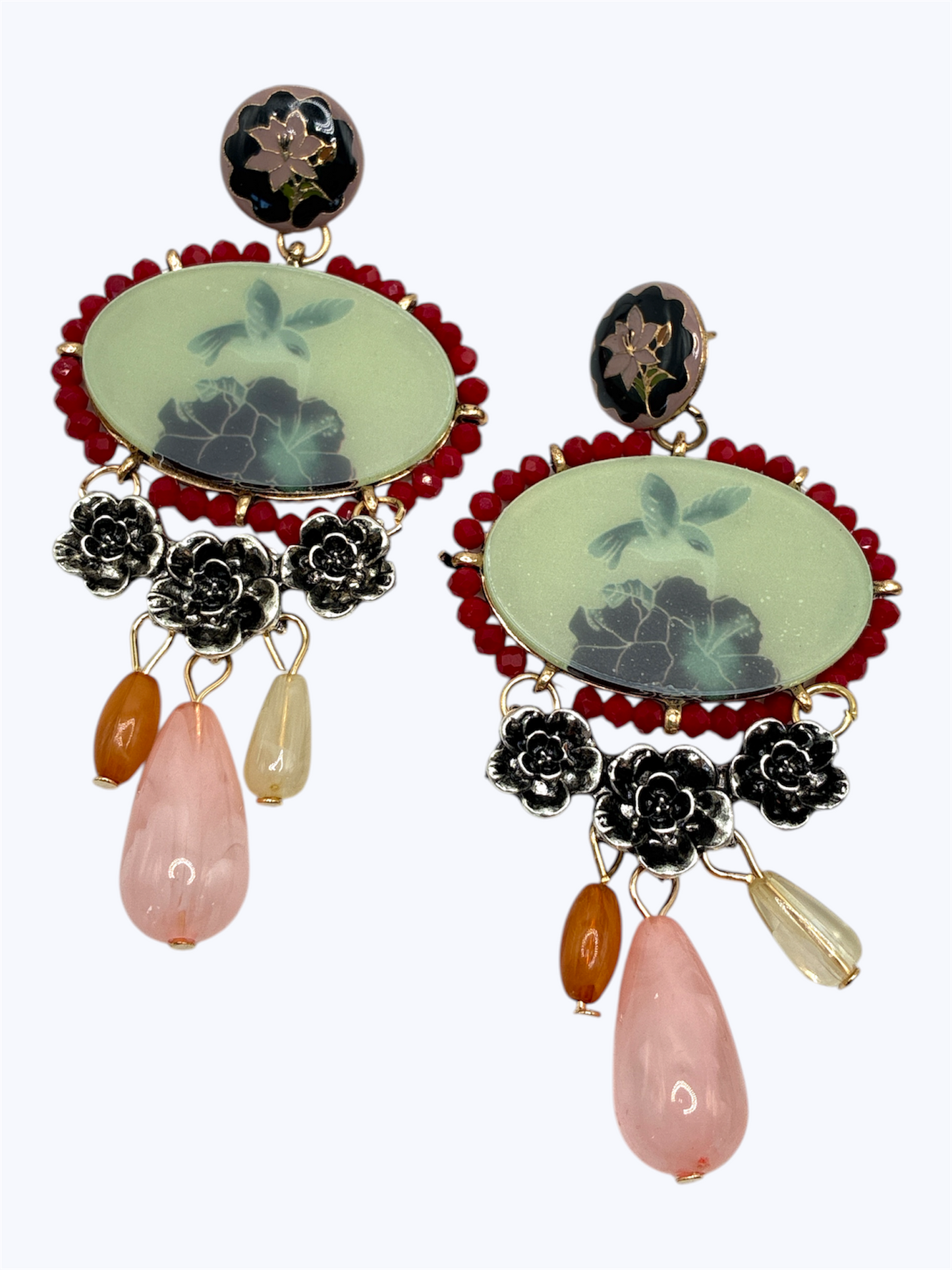 Vintage-inspired statement earrings with floral detailing, pastel stones, and pink teardrop accents